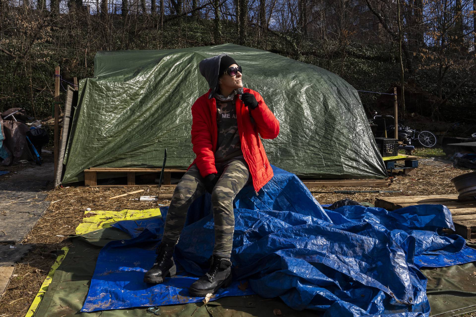 Stephanie Lovelace and her partner have lived in a tent in Wyman Park Dell since the summer. They along with several others in a rotating homeless encampment are going to have to leave the park as the city gradually cleans it out this month. She is pictured here on February 13, 2024.