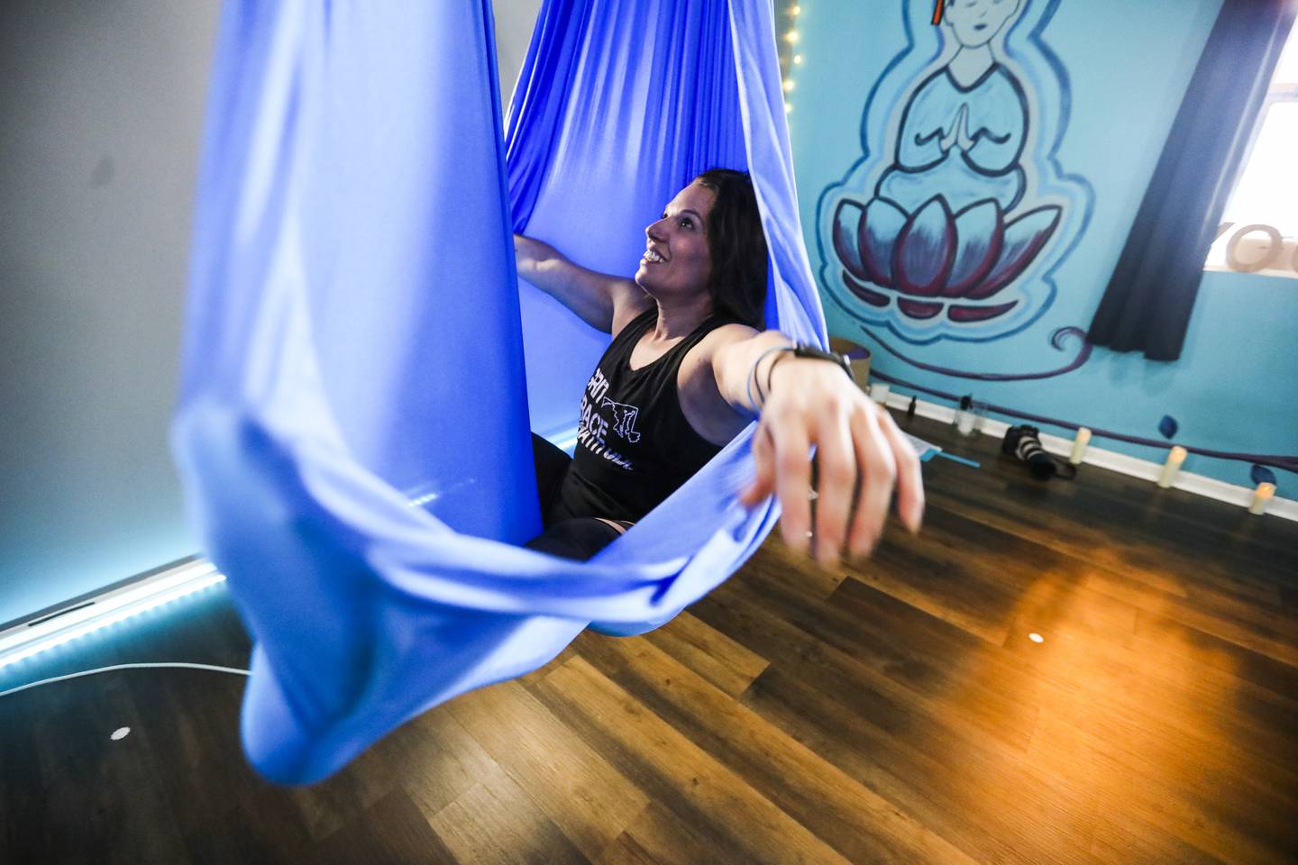 An aerial yoga class takes place at Break Away Yoga with owner Jenn Lucas in Parkville, MD on July 6, 2022.