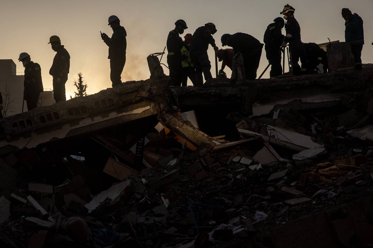 Volunteers and rescue teams search a destroyed building on February 12, 2023 in Adiyaman, Turkey.