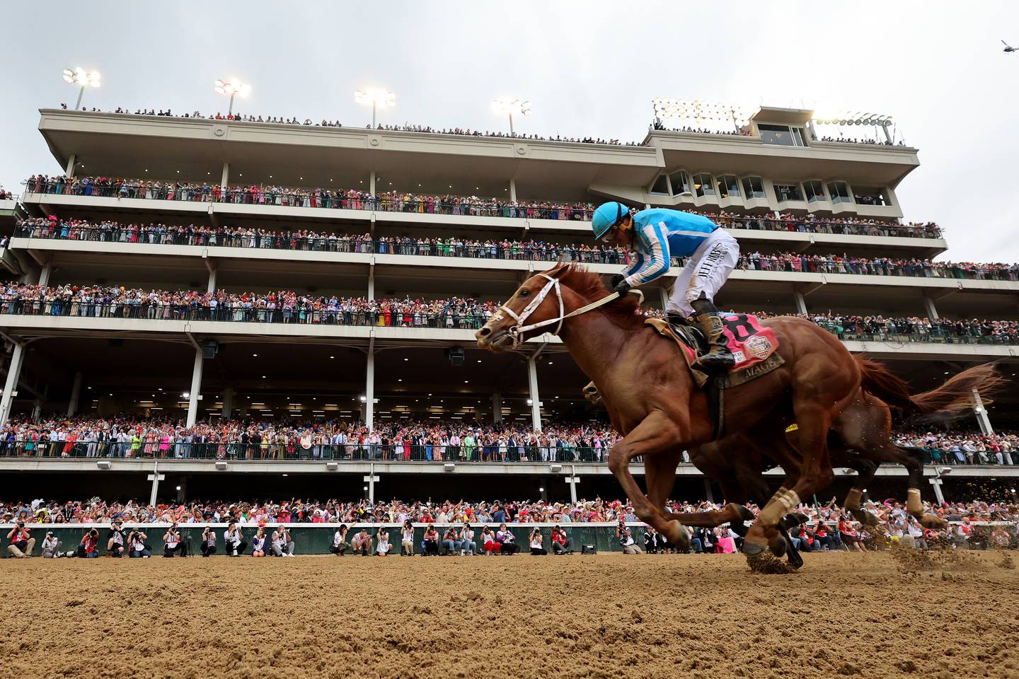 Mage, ridden by jockey Javier Castellano, crosses the finish line to win the 149th running of the Kentucky Derby.