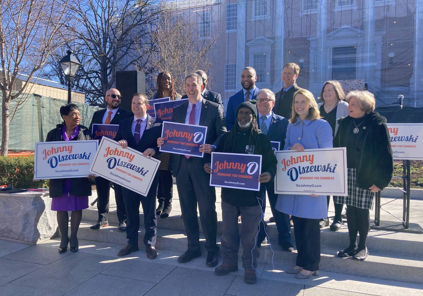 Johnny Olszewski Jr., a candidate for Congress, poses with lawmakers who endorsed him, as well as Duane "Shorty" Davis, to his left, on Lawyers Mall in Annapolis on Monday, Feb. 5, 2024.