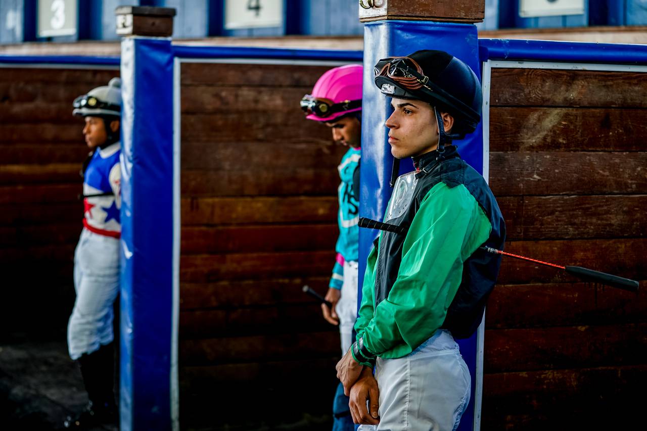 Axel waits for riders up in the paddock at Laurel. Friend and fellow jockey school alum Luis Rivera is in the next stall over.