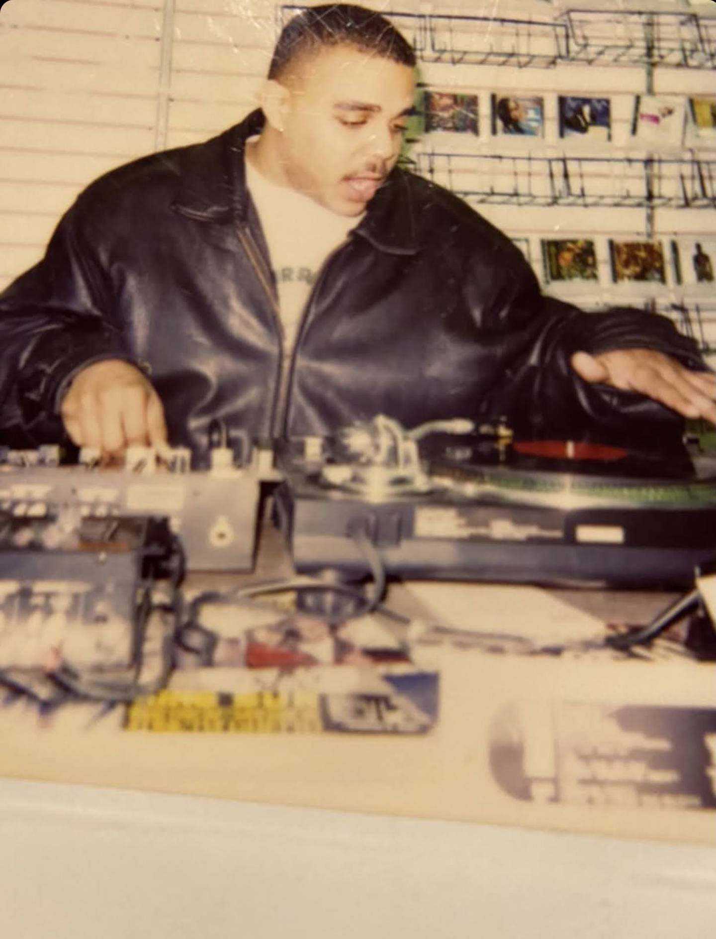 An throwback photo of DJ Shawn "Ceez" Caesar on the turntables in the middle of a set.
