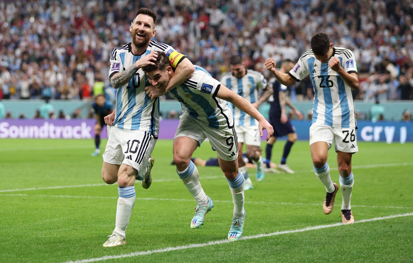 Julian Alvarez celebrates with Lionel Messi of Argentina after scoring the team's second goal during the FIFA World Cup Qatar 2022 semi final match between Argentina and Croatia at Lusail Stadium on December 13, 2022 in Lusail City, Qatar.