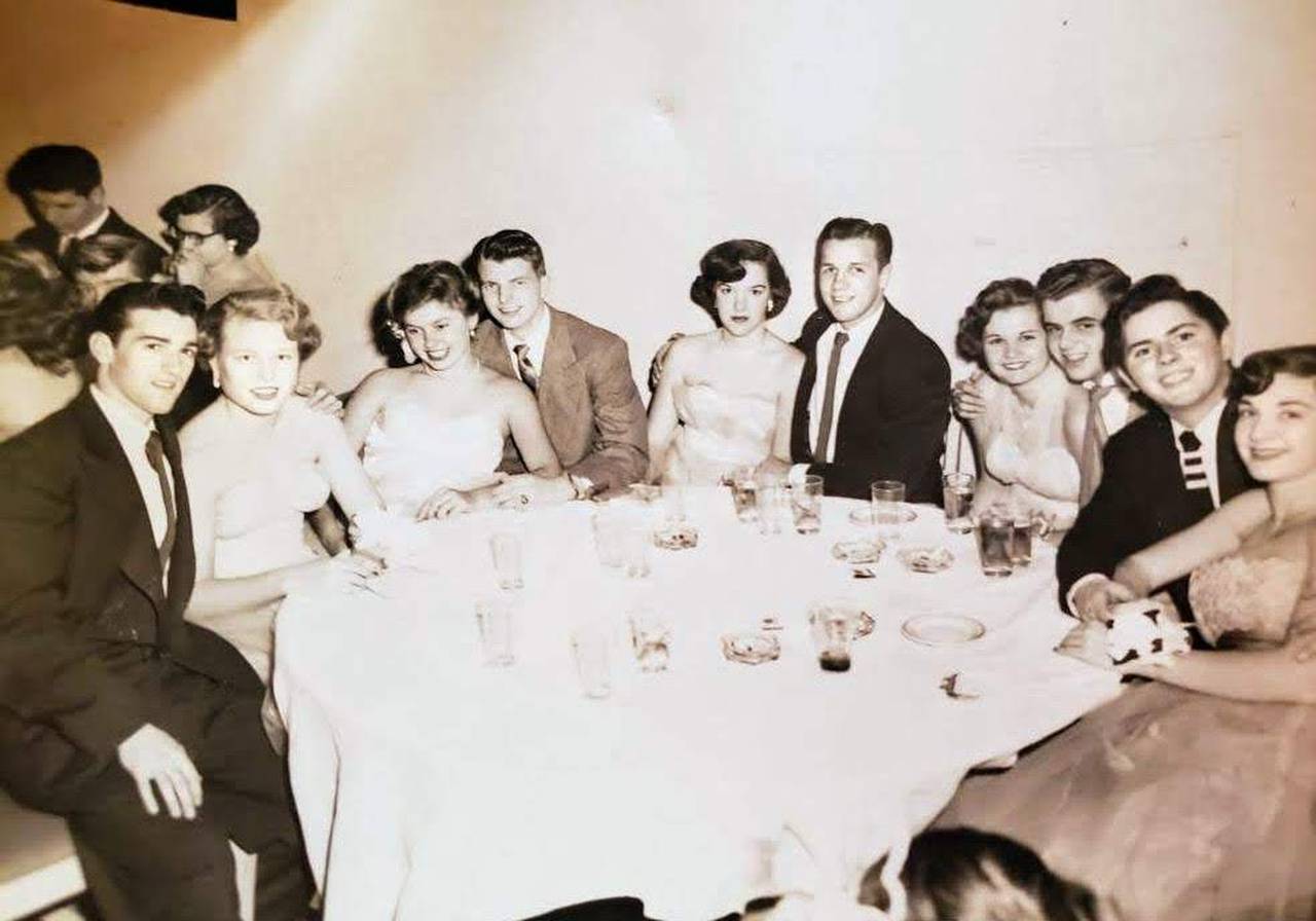 My father and mother, seated to the far left, dressed to the nines in the 1950s.