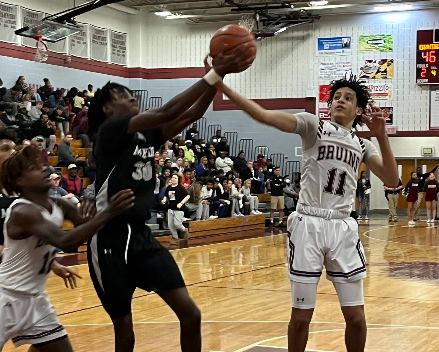 Meade's Shaun Jones (left) and Broadneck's Jordan Brown vie for a rebound during Wednesday's key Anne Arundel County boys basketball contest. The Bruins dominated the No. 14 Mustangs in the second half en route for a 58-42 victory in Cape St. Claire.