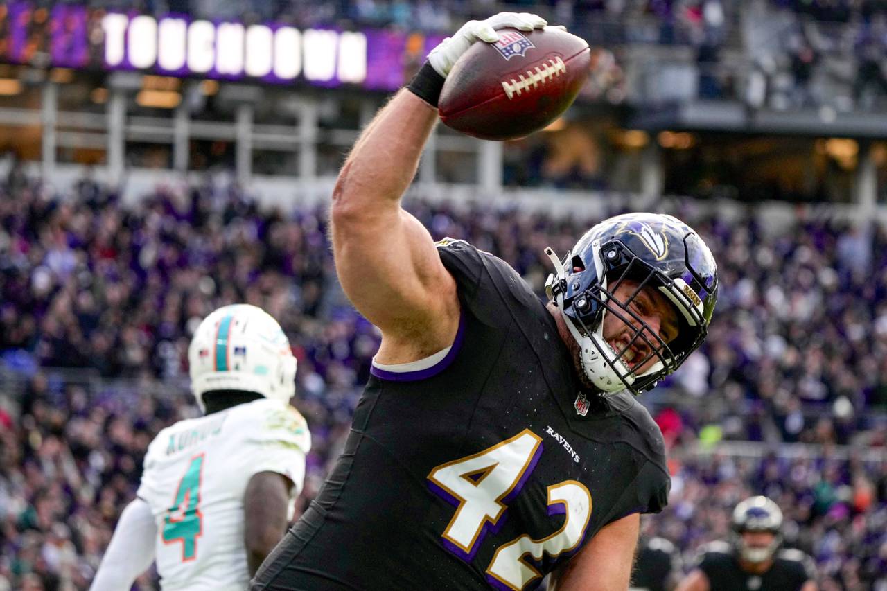Baltimore Ravens fullback Patrick Ricard (42) spikes the ball after scoring a touchdown against the Miami Dolphins at M&T Bank Stadium on Sunday, December 31, 2023. The Ravens won, 56-19, to secure the best record in the AFC.