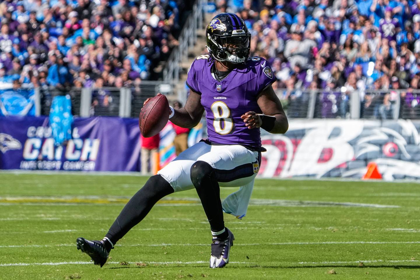 Baltimore Ravens quarterback Lamar Jackson (8) runs with the ball during the first quarter against the Detroit Lions at M&T Bank Stadium on Sunday, Oct. 22, 2023.