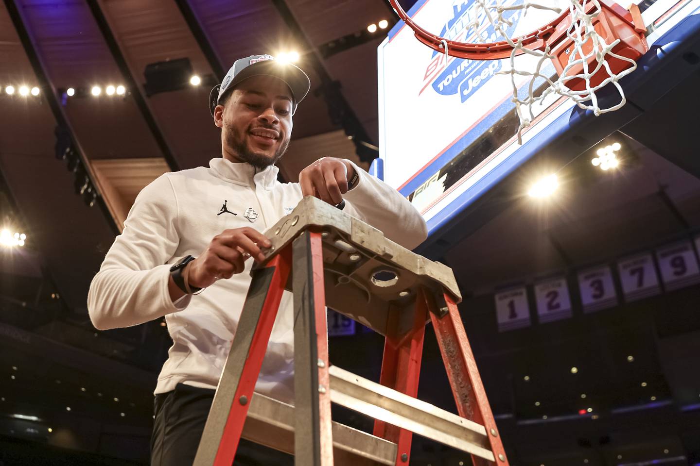 Dayshawn Wells cuts down the nets at Madison Square Garden after Marquette won the 2023 Big East Tournament championship.