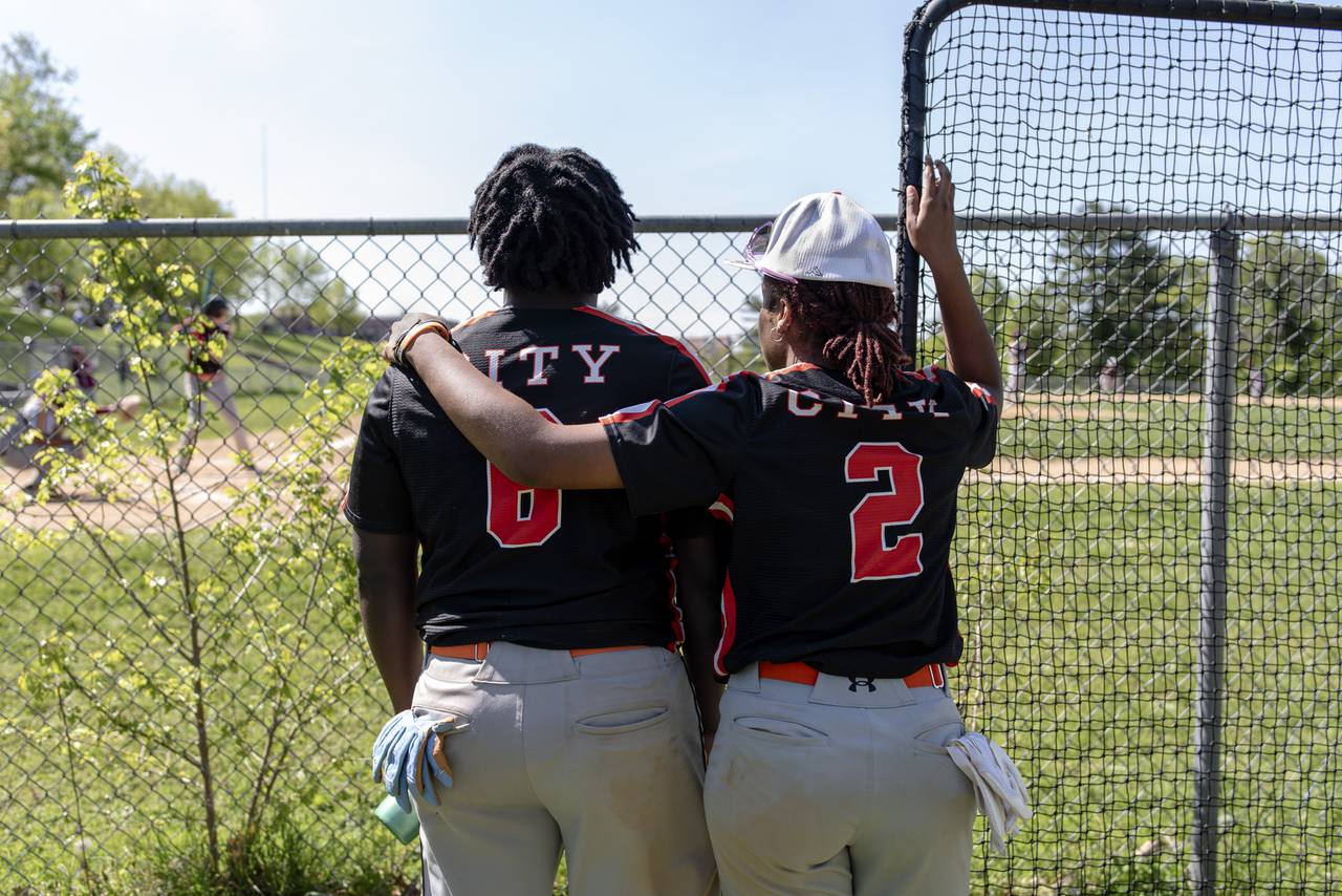 Sibling teammates, Rocksann Smith (No. 2) and Rahniah Smith (No. 6), of the Baltimore City College Knights Varsity Baseball Team watch their team at bat against Dunbar on 4/26/2024 in Baltimore, MD.