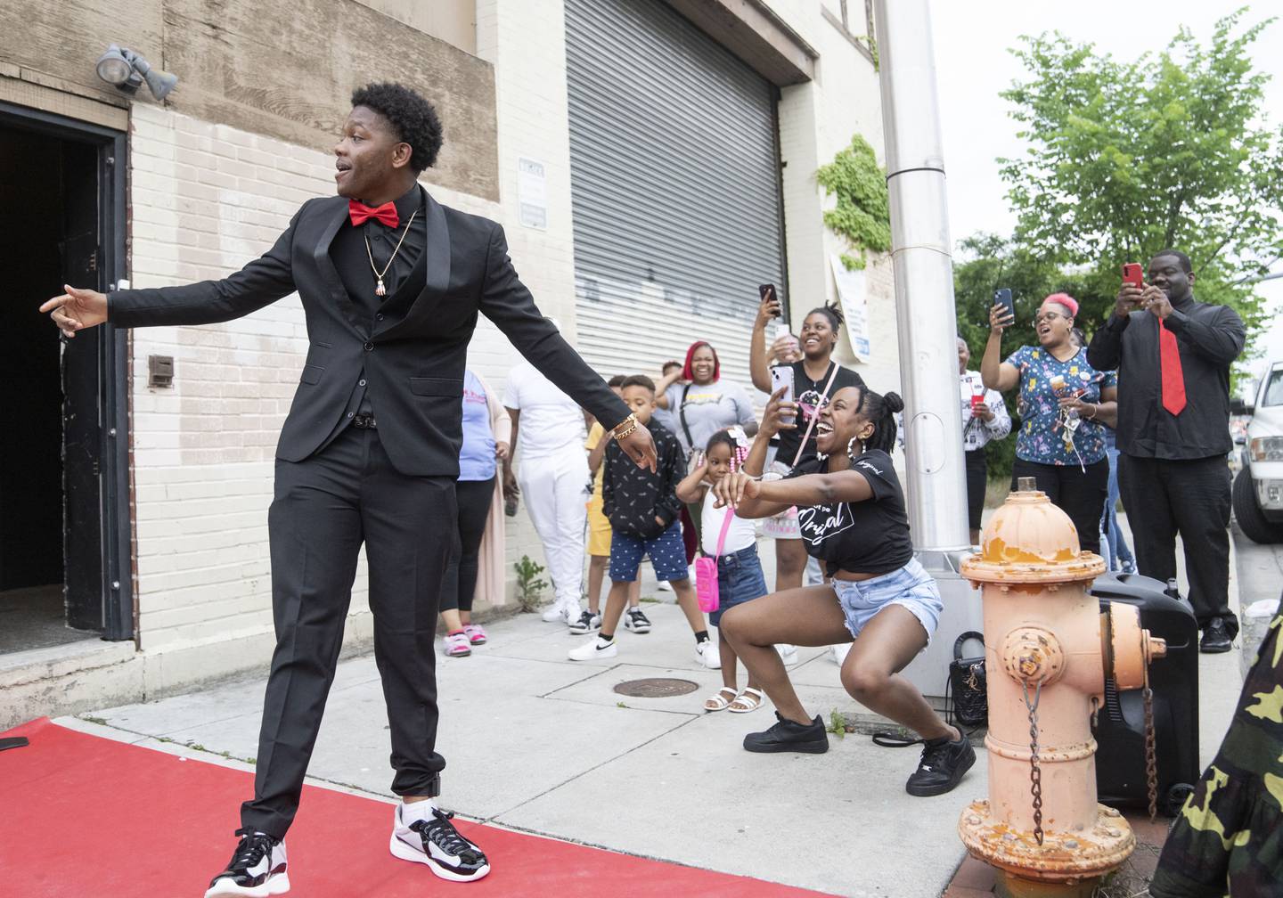 Myron Green walks out of his prom send off party to a crowd of his loved cheering, in Baltimore, Tuesday, May 16, 2023.