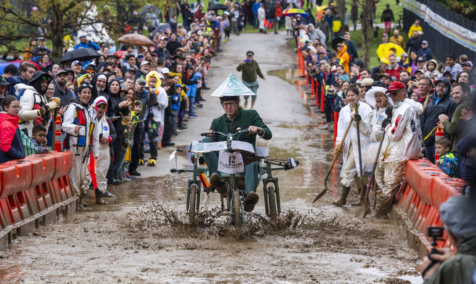Cyclists participate in the Kinetic Sculpture Race hosted by the American Visionary Art Museum on May 4, 2024. The mud obstacle at Patterson Park is the last and the hardest.