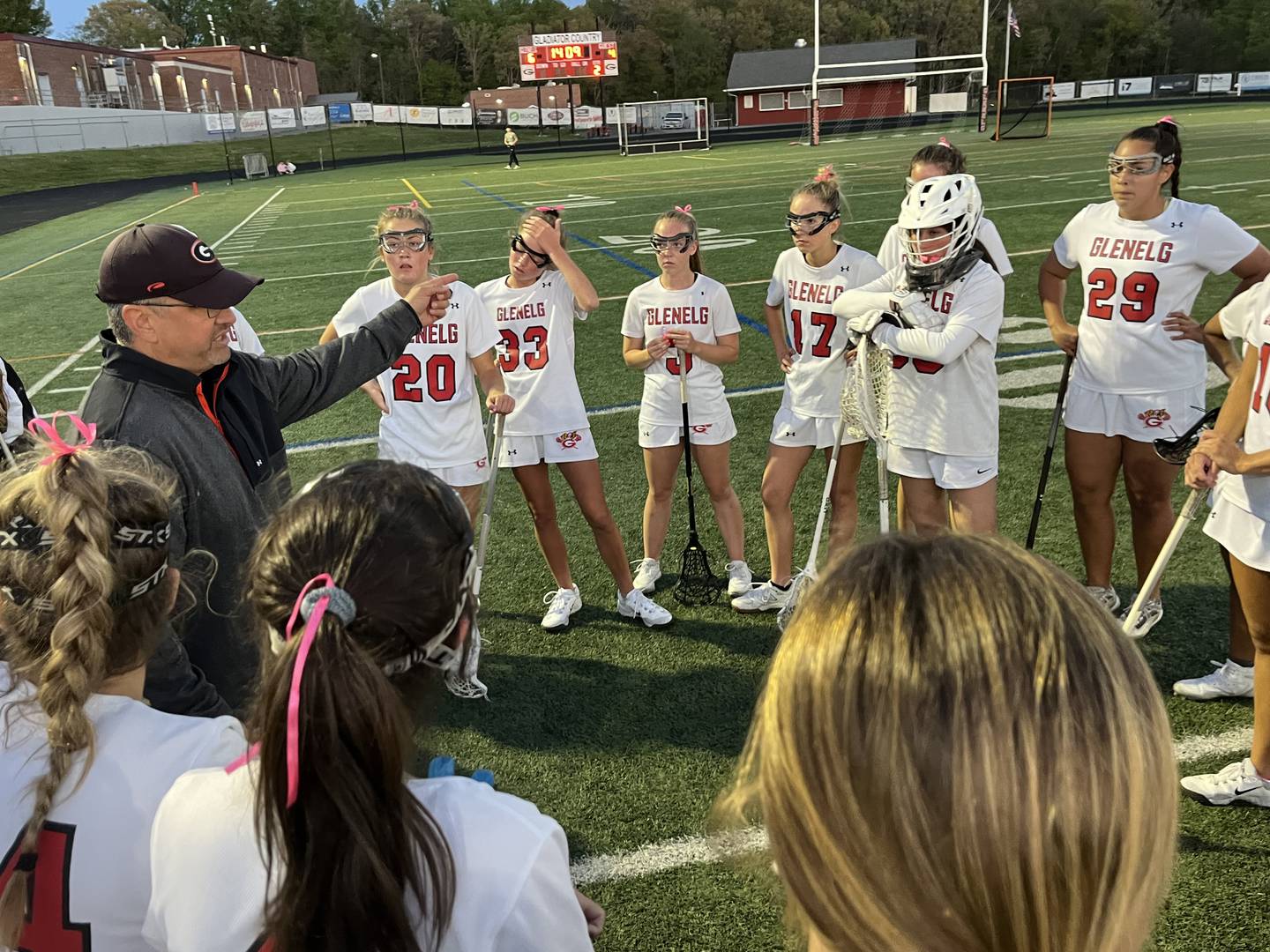 Glenelg girls lacrosse coach Alex Pagnotta (left) talks to his team during a timeout in Tuesday's Howard County match with Marriotts Ridge. The No. 7 Gladiators overcame a shaky second half effort to post a 7-5 victory over the 13th-ranked Mustangs in Western Howard County.