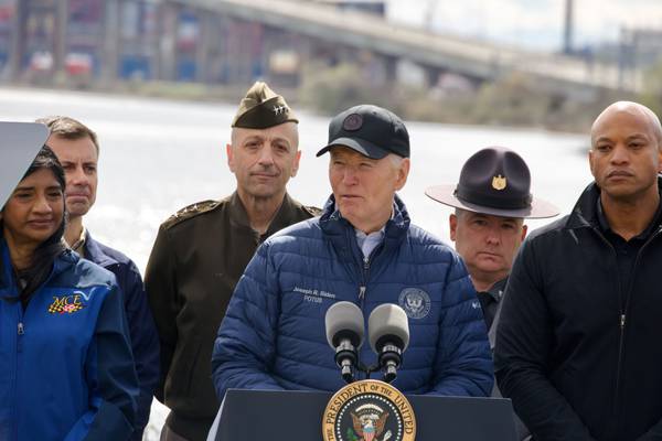 President Joe Biden speaks in front of the wreckage of the Francis Scott Key Bridge, flagged by Lt. Gov. Aruna Miller and Gov. Wes Moore.
