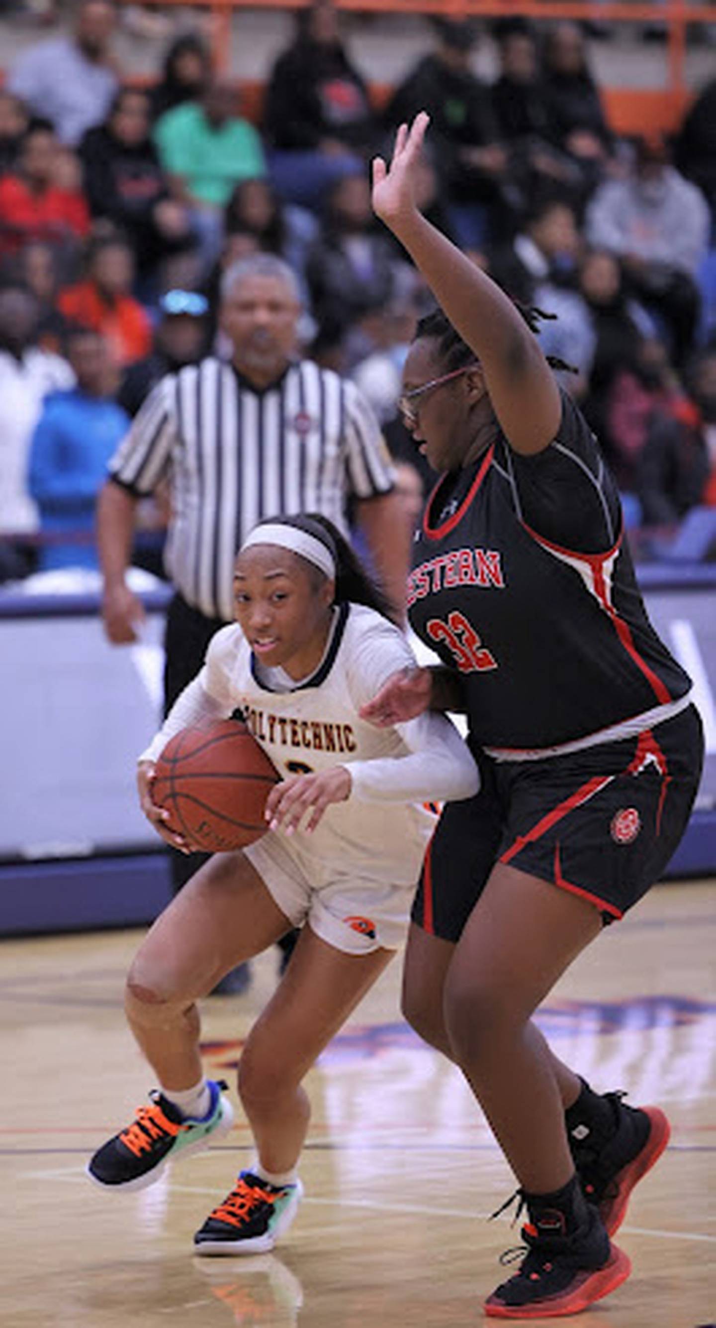 Poly's Da'Brya Clark (left) is defended by Western's Breasia Coit during Tuesday's Baltimore City girls basketball championship game. Clark finished with 19 points including four free throws in the final 30 seconds as the No. 3 Engineers dethroned the 13th-ranked Doves as champs with a 52-44 victory at Morgan State University.