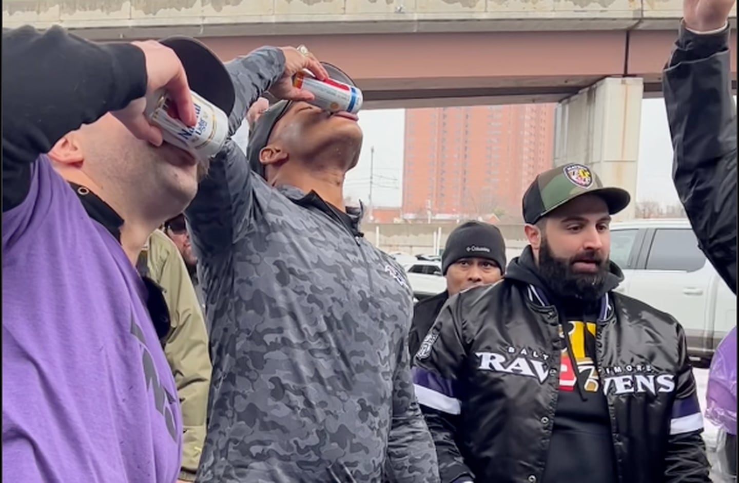 Gov. Wes Moore shotguns what appears to be a Hoop Tea alcoholic beverage with tailgaters outside the Ravens game on Jan. 28, 2024.