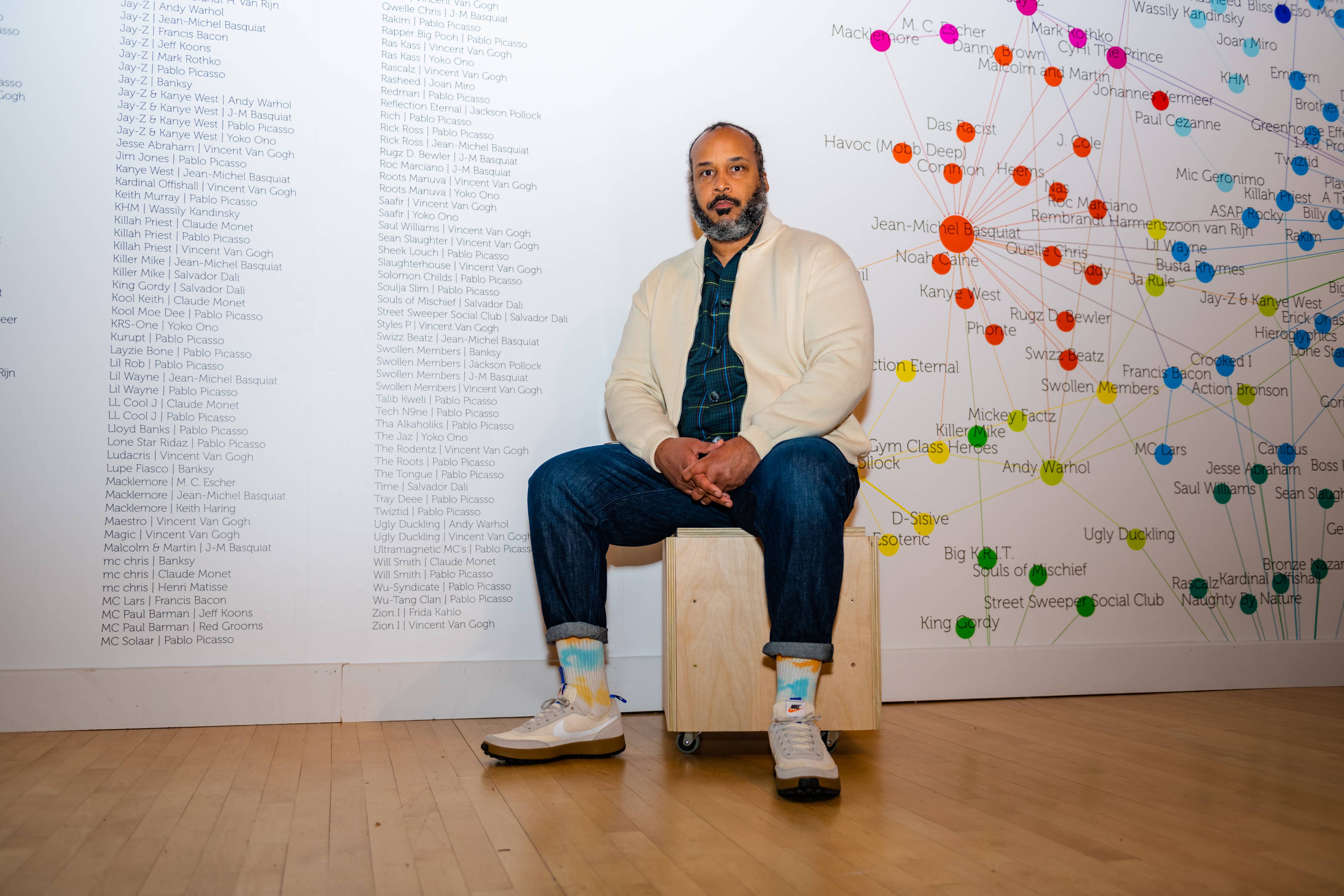 Tahir Hemphill takes a portrait in his exhibition focused on his many multimedia works, and data visualization in his gallery space at UMBC in Baltimore, Md., on February 2, 2023.