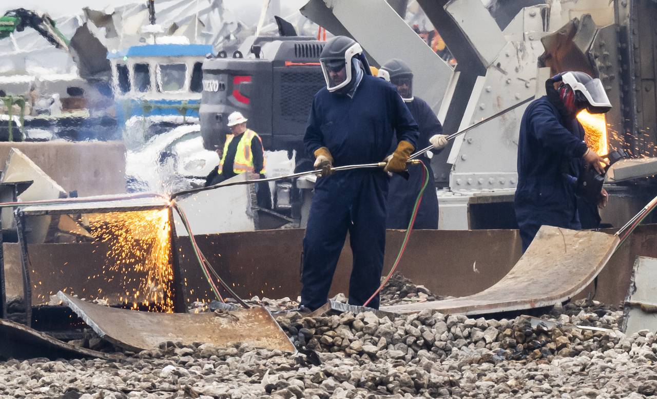 Workers cut up the remanants of the Francis Scott Key Bridge to prepare them to be recycled on April 12, 2024 a few weeks after the collapse. . The pieces are gathered from the water and taken to the port of Tradepoint Atlantic, which sits directly adjacent to where the bridge once stood.