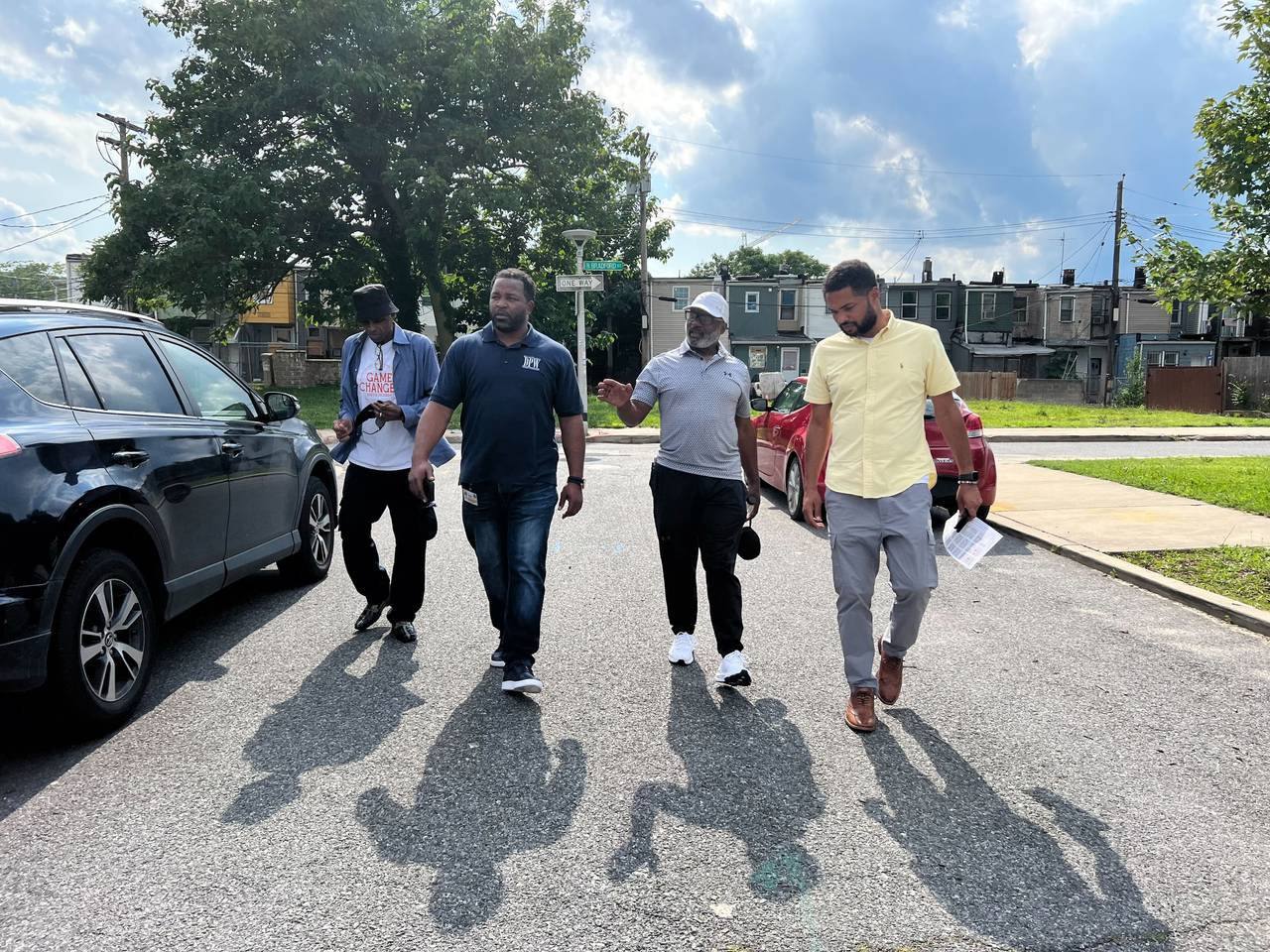 From right to left, Rick Leandry of the Mayor's Office of Neighborhood Engagement and Safety, neighborhood leader Terry "Uncle T" Williams, and Terrance Brown of the Department of Public Works walk the area of North Milton and Milliman Streets, searching for quality of life issues for city workers to address.