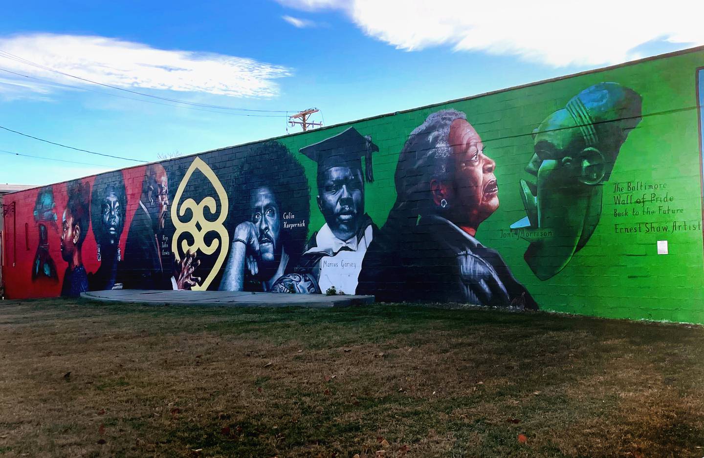 This is the Wall of Pride, 1601 Carey Street in Sandtown-Winchester by Ernest Shaw. The mural is a continuation of the work of late artist Pontella Mason, responsible for more than 30 pieces of public art in Baltimore City.
