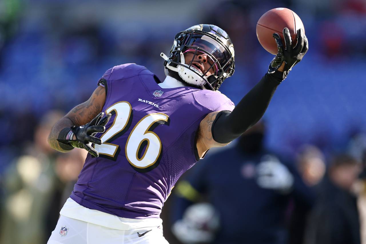 BALTIMORE, MARYLAND - NOVEMBER 20: Geno Stone #26 of the Baltimore Ravens warms up before a game against the Carolina Panthers at M&T Bank Stadium on November 20, 2022 in Baltimore, Maryland.