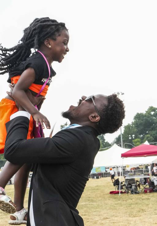 Bill Morris, 25, and daughter Adora Tarley, 4, dance at AFRAM Juneteenth Festival on June 17, 2023 at Druid Hill Park. This is the first official Baltimore Club Music Day.