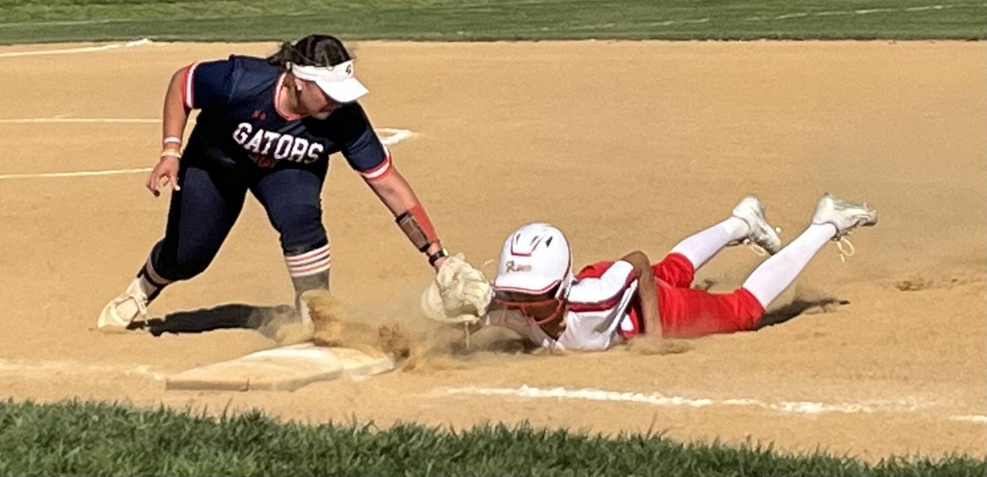 Reservoir first basemen Cambell Sagin (left) puts tag on Glenelg's Abiola Owens on a pickoff play during Thursday's Howard County softball match. The No. 2 Gators improved to 7-0 with a 7-2 victory over the Gladiators in Western Howard County.