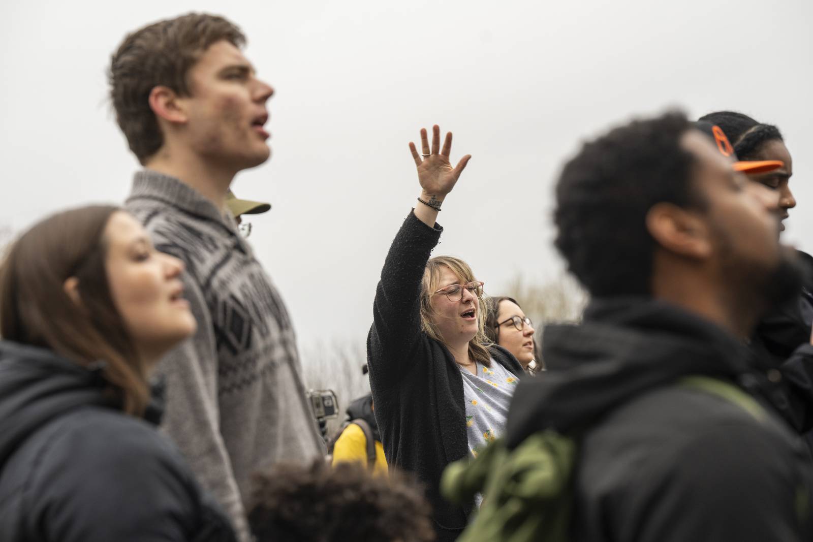 Community members participated in a prayer circle held in front of the Patterson Park Observatory despite the rainy morning on March 28, 2024. Redemption City Church guided the community in prayer and hymns.