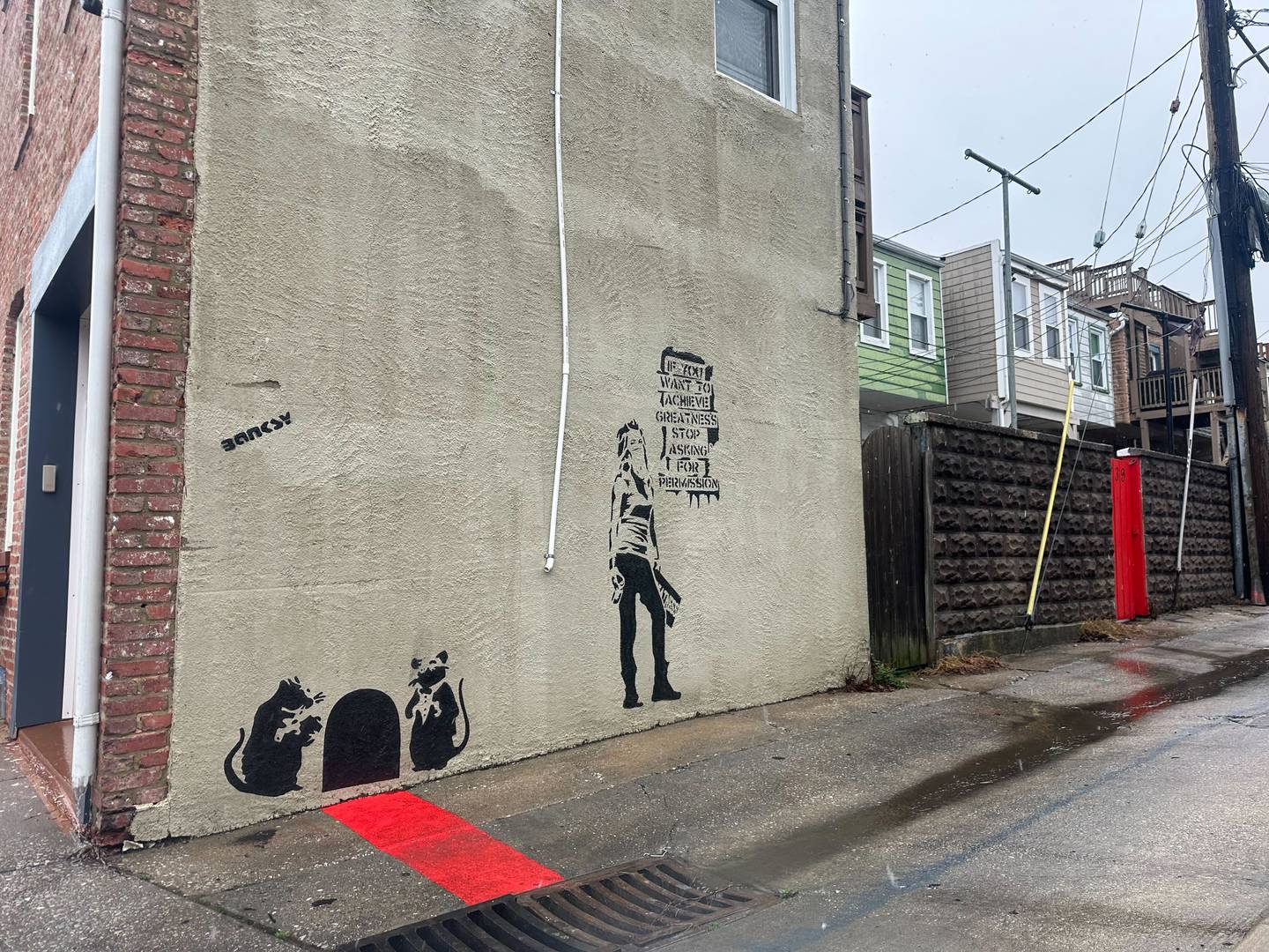 Graffiti in an alley off Fait Avenue near S. Potomac Street in Canton looks like it could be done by the artist Banksy. But both images are recreations of existing pieces.