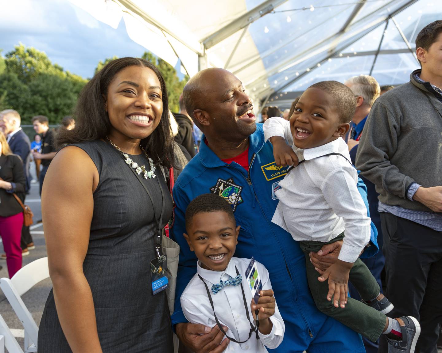 From left: Sade Newson, 32, Noah Newson, 6, Leland Melvin, 58, Aden Newson, 3, pose for a quick photo after opening remarks at the DART Impact Event held at the Johns Hopkins Applied Physics Lab, in Laurel, MD. Noah, an aspiring scientist, is shy meeting Leland Melvin the engineer, and retired NASA astronaut.