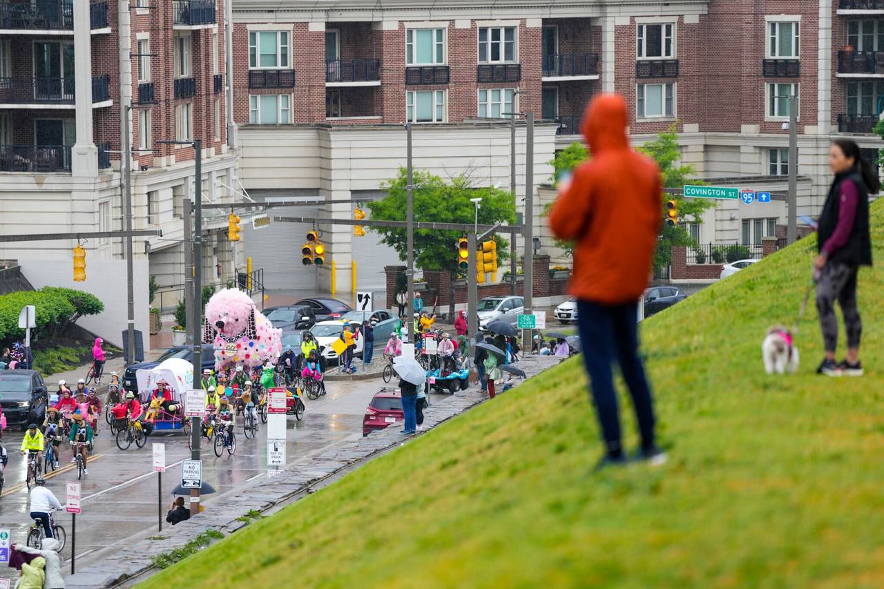 Spectators watch the Kinetic Sculpture Race begin from Federal Hill Park on May 4, 2024.