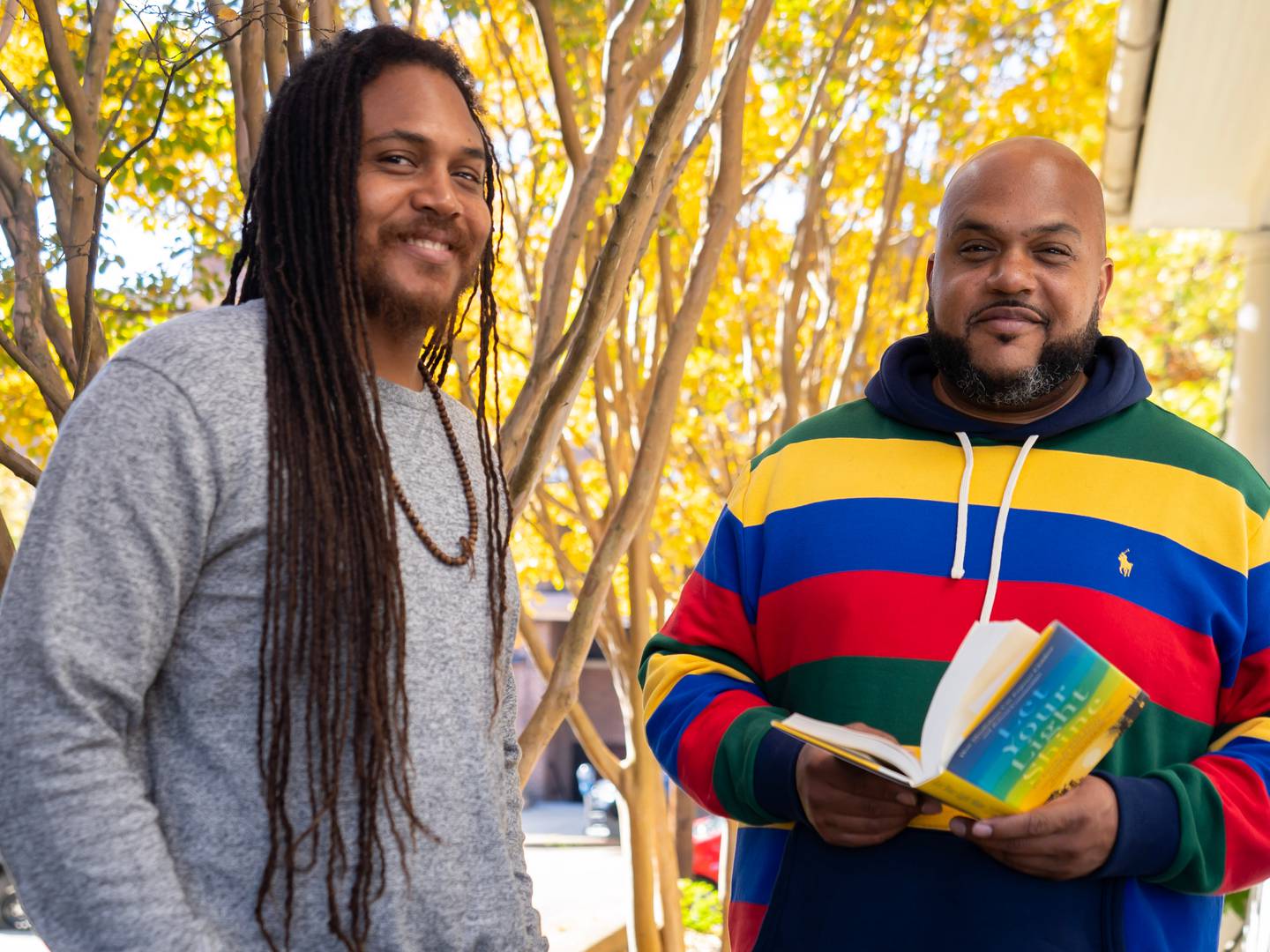 Atman Smith, left, and his brother Ali Smith, two of the authors of Let Your Light Shine, stand in front of their Baltimore office. The book comes out Tuesday, October 18.