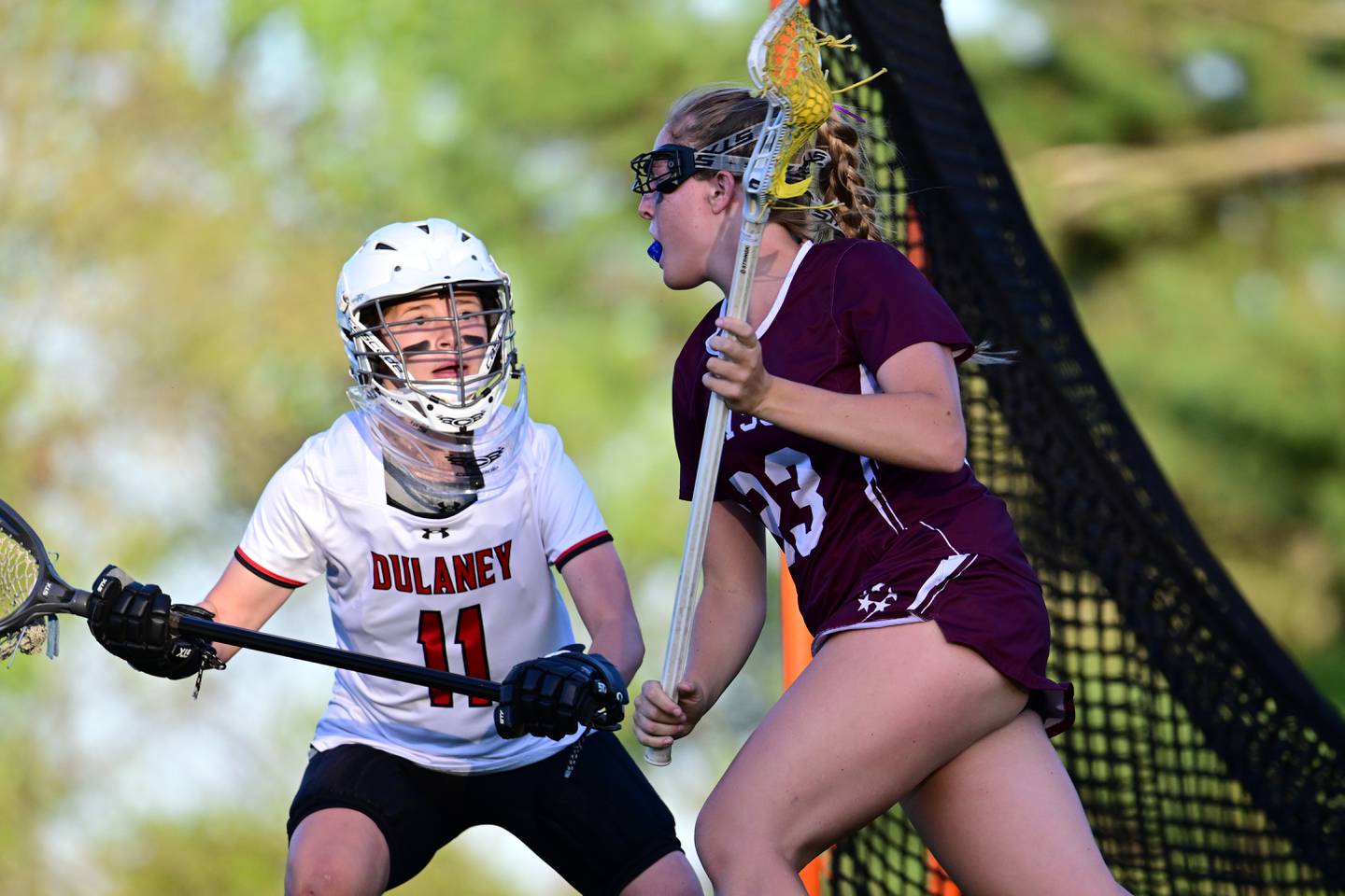 Towson's Chloe Gibson (23) looks for an open teammate while Dulaney goalie Audrey Simoes keeps an eye on her in Wednesday's showdown between two of Baltimore County's top girls lacrosse teams. Gibson had a goal and an assist as No. 15 Towson won, 11-9. Simoes made 10 saves.