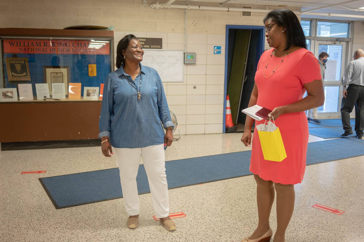 Jacqueline Williams stands with Superintendent Sonja Brookins Santelises stand in the hallway of Baltimore Polytechnic Institute.