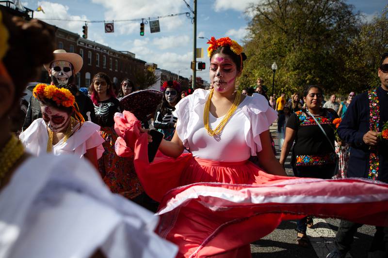 11/5/22 – Salma Ruiz marches in the Creative Alliance's Día de los Muertos parade as part of of the Jóvenes en Acción group on Saturday. The celebration also featured live music, traditional art and food, and dance performances.