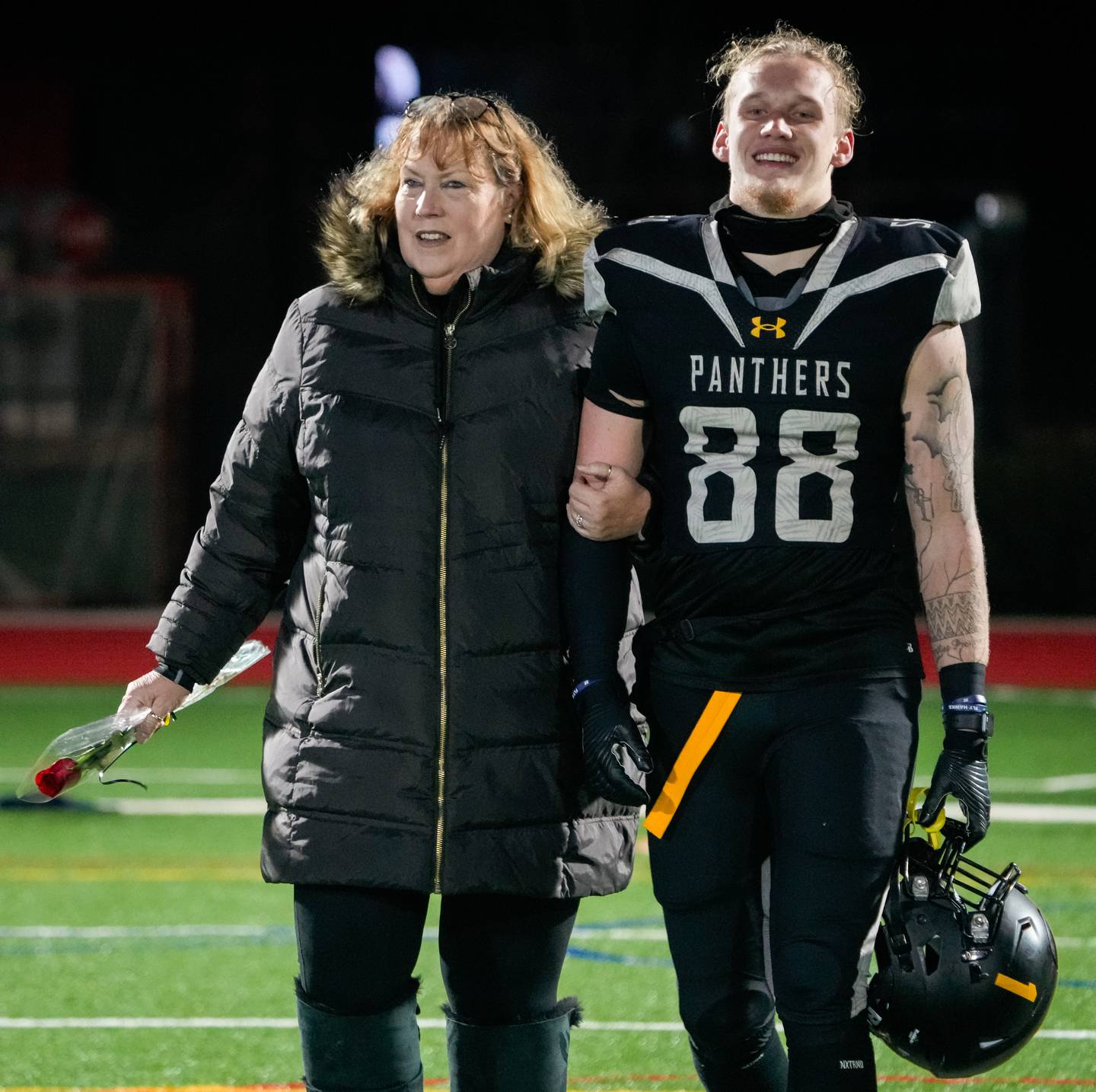 St. Frances senior tight end Chase Wilkens walks with his mom as he’s honored during senior night at Under Armour Stadium, which was their final home game of the season, on Friday, Nov. 10, 2023.