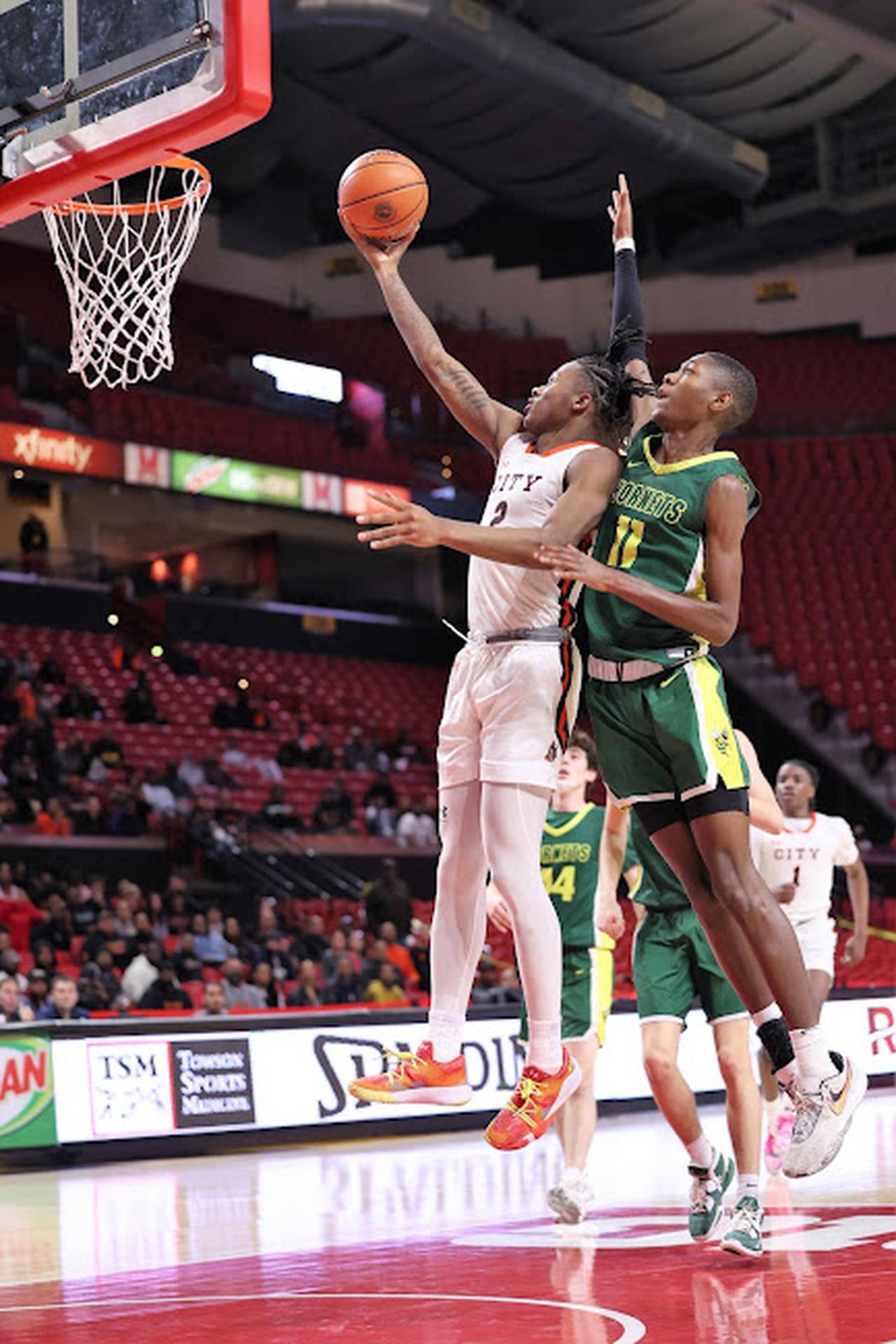 City's Cam Horton goes up for two points as Damascus' Michael Baskerville defends during Thursday's Class 3A state boys basketball championship game at the University of Maryland.