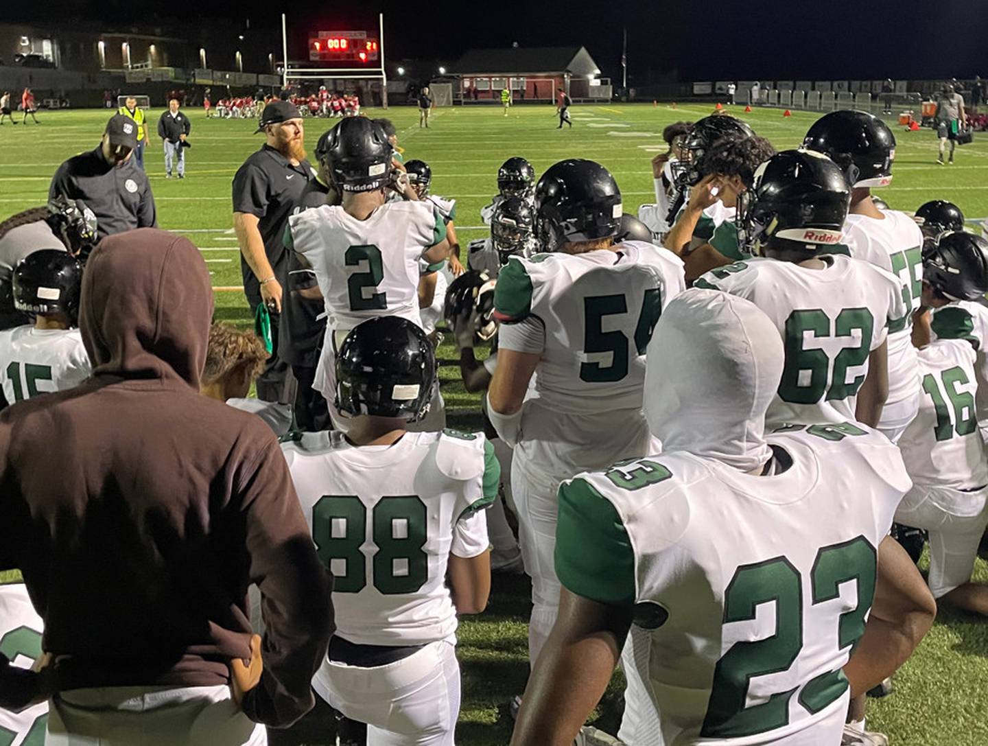 Atholton head football coach Dillan Watson addresses his squad following its 21-7 victory over Howard County rival Glenelg, on Friday.