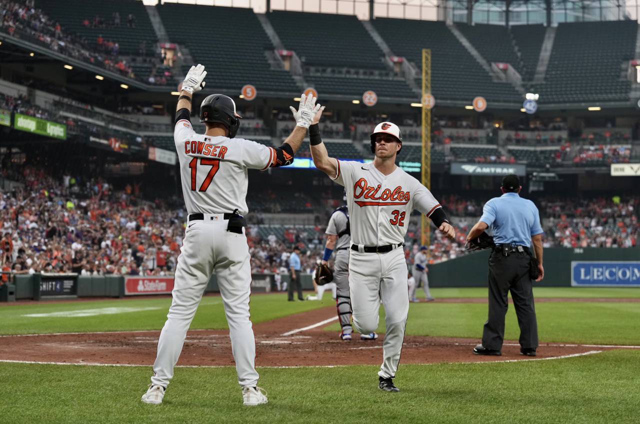 Ryan O’Hearn and Colton Cowser high-five after O’Hearn scores points during the Orioles vs Dodgers game on July 18, 2023 at Camden Yards. (Kaitlin Newman / The Baltimore Banner)