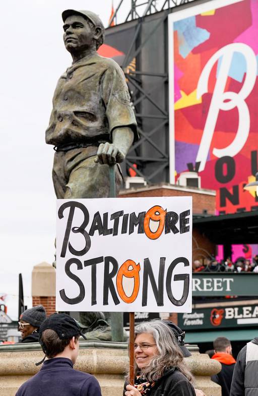 Stacy Gilbert holds a “Baltimore Strong” sign in front of the Babe Ruth statue. While she wasn’t able to get tickets to today’s game, she lives in the neighborhood in a house Babe Ruth once did and wanted to come out and show her support.