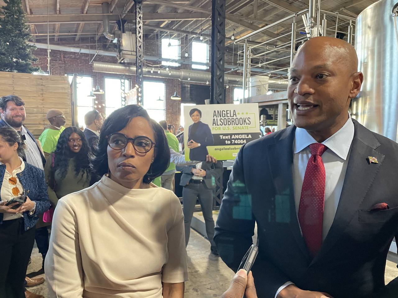 Prince George's County Executive Angela Alsobrooks and Gov. Wes Moore speak with reporters after Moore endorsed Alsobrooks in the 2024 race for U.S. Senate at an event at Monument City Brewing in Baltimore on Monday, Oct. 23, 2023.