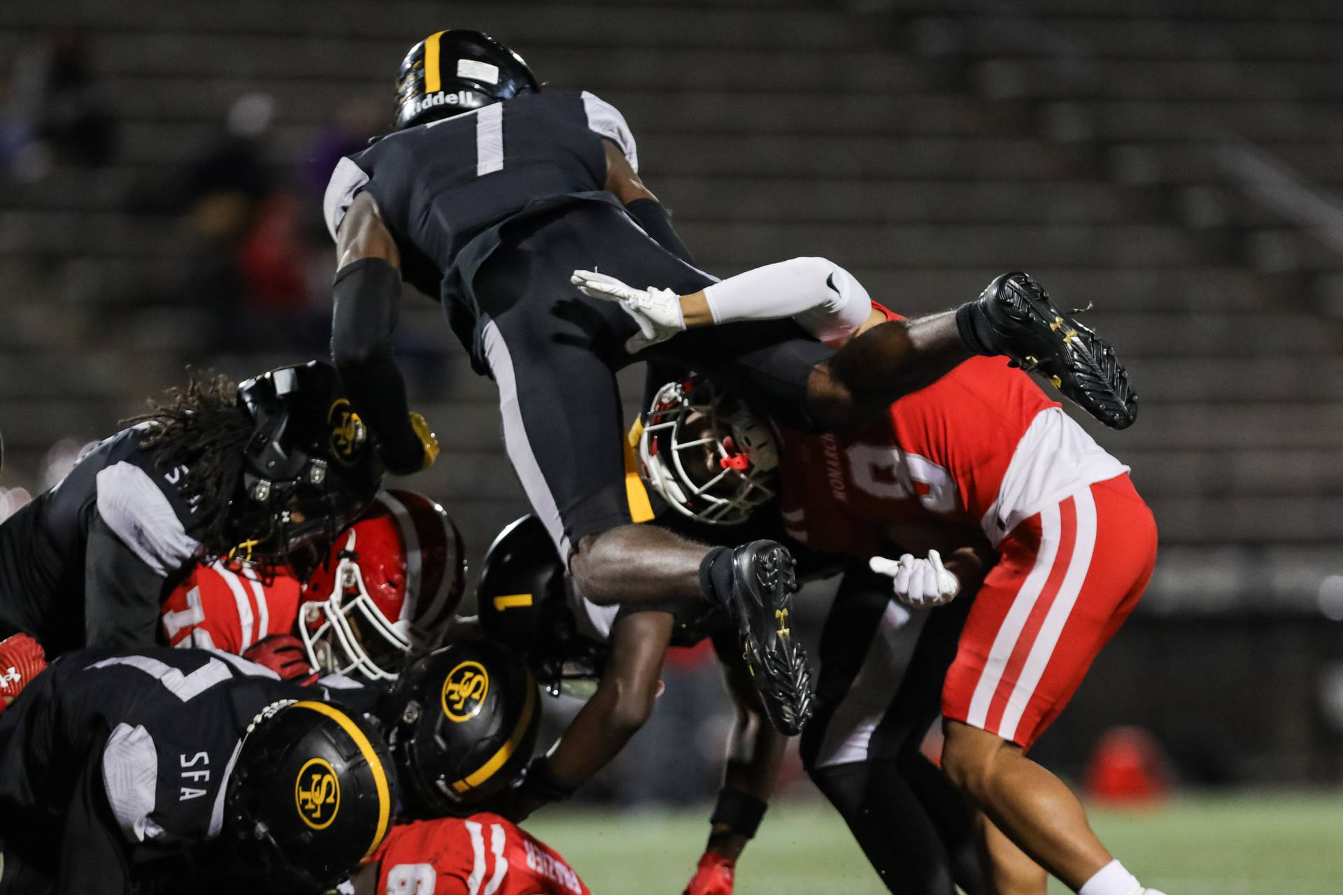BB-SP-St. Frances-Mater Dei St Frances Quarterback, Ify Obidegwu #7, jumping over Mater Dei's players to defend his teammates.