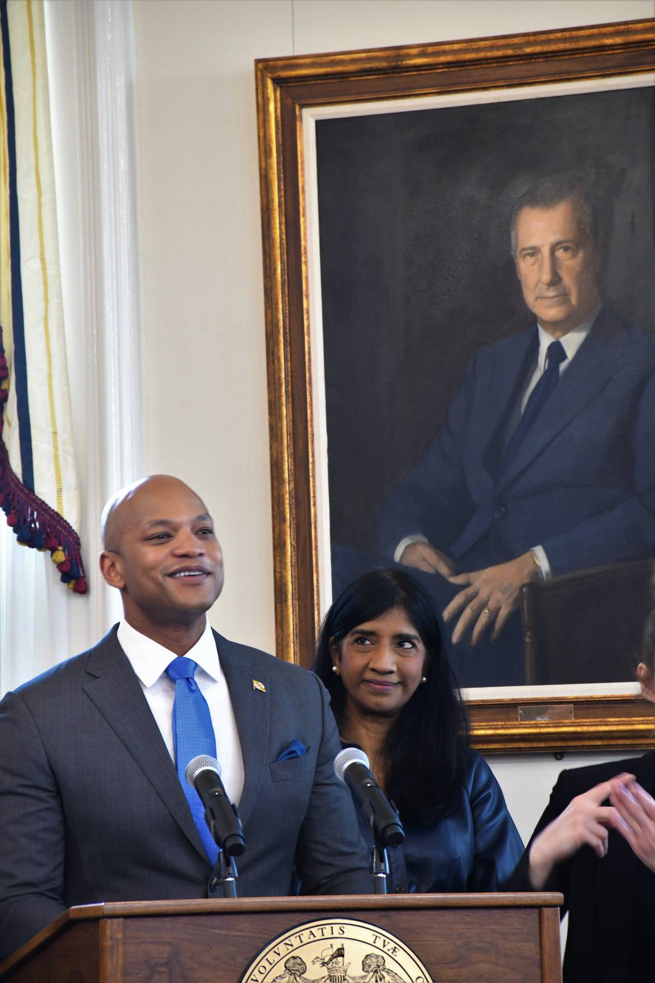 A portrait of Spiro Agnew, former governor and U.S. vice president, hangs behind Gov. Wes Moore as the governor speaks during a bill-signing ceremony at the State House on April 24, 2023. Beside Moore is Lt. Gov. Aruna Miller.