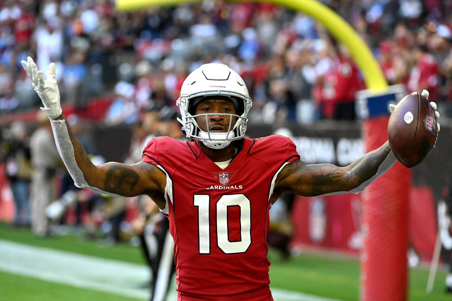 GLENDALE, ARIZONA - NOVEMBER 27: DeAndre Hopkins #10 of the Arizona Cardinals celebrates after scoring a touchdown in the first quarter of a game against the Los Angeles Chargers at State Farm Stadium on November 27, 2022 in Glendale, Arizona.