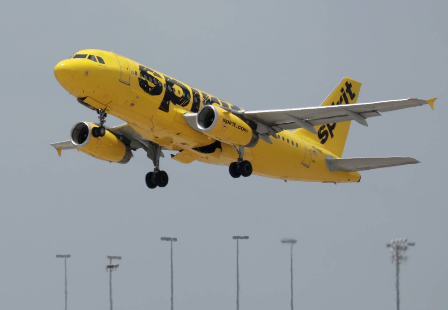 A Spirit airlines plane takes off from Miami International Airport on July 27, 2022 in Miami, Florida. Spirit Airlines Inc. shareholders are voting whether to merge with Frontier Airlines or JetBlue Airways Corp.