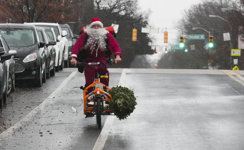 Every weekend from Thanksgiving to Christmas, Todd Coleman and Mike Santoro dress as Santa, strap Christmas Trees on their bikes, fill their backpacks with pulled pork sandwiches and deliver them to various neighborhoods.