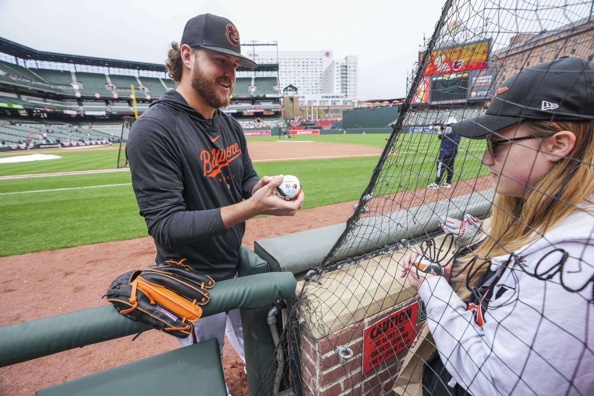 Pat McFaul of Rosedale also know by his nickname “Old School” high-fives fans as they make their way around Camden yards before the Home Opener Orioles against divisional rivals New York Yankees.