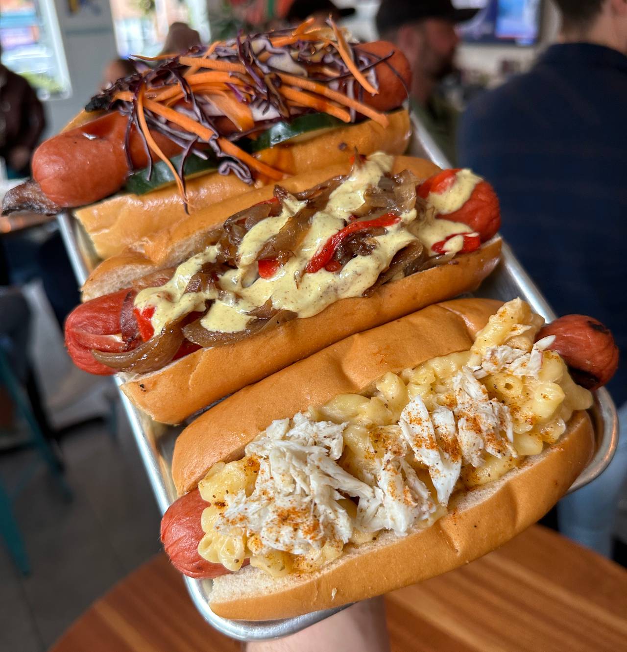 Stuggy's crab mac and cheese hot dog, foreground.