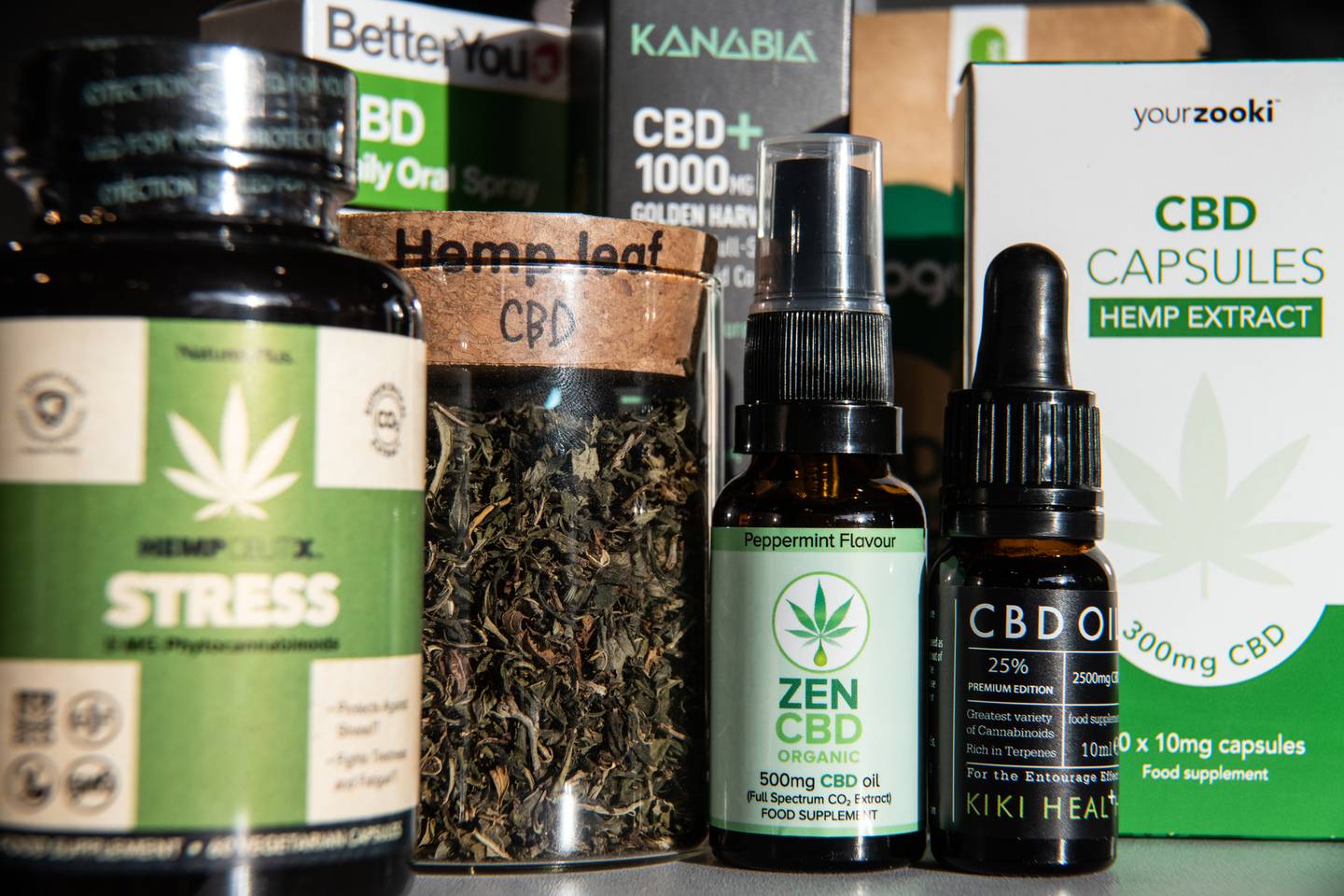 A collection of small jars and boxes that contain hemp and CBD.