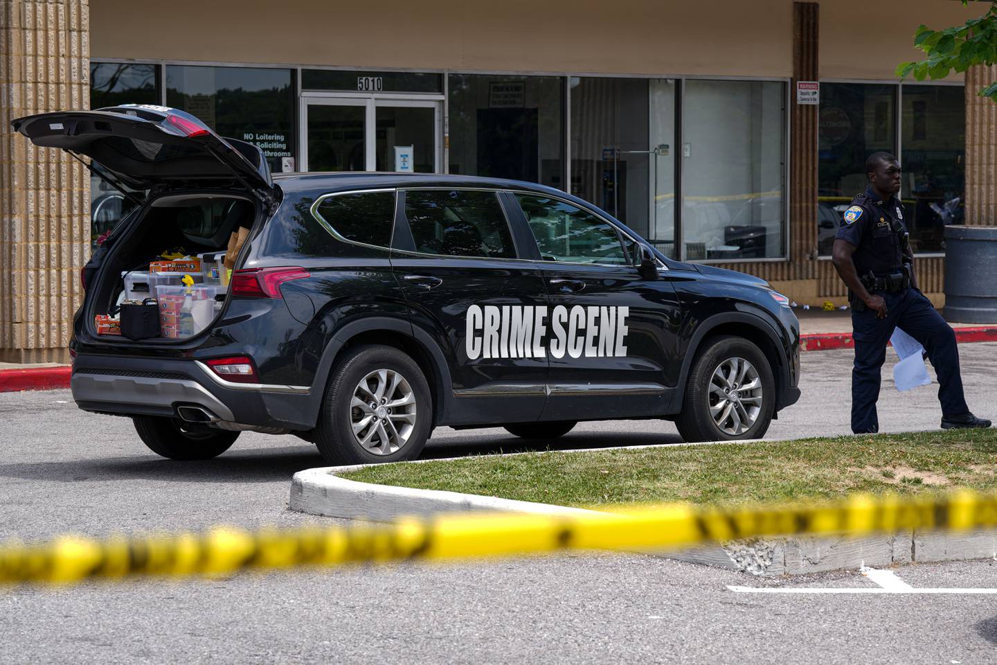 6/22/22—Police investigate a crime scene where three men were shot in a Northeast Baltimore shopping center Wednesday morning.